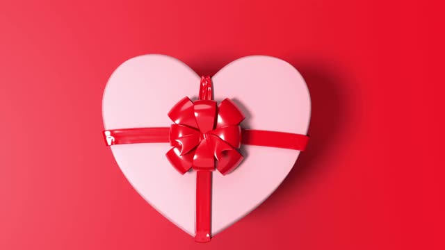 Loop Ready Love is Coming Out of a Heart Shape White Gift Box with Red Ribbon on Red Loop Ready File in 4K分辨率视频素材