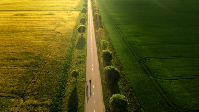 空中骑自行车的人在乡村公路上骑自行车视频素材