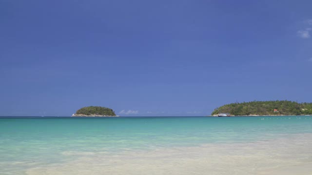 泰国普吉岛著名的旅游胜地卡塔海滩的游客和湛蓝的海水视频素材