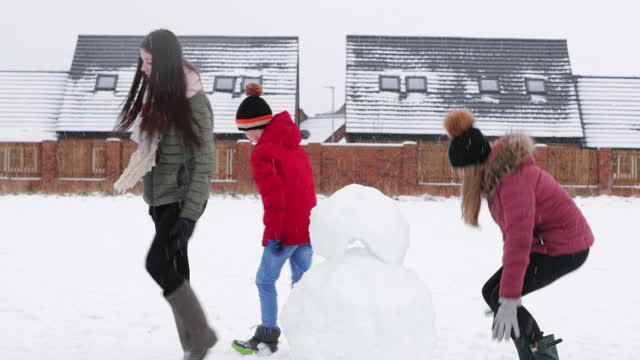 兄弟姐妹堆雪人视频素材