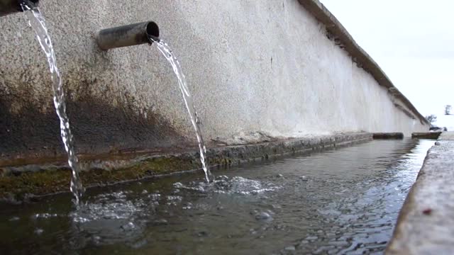 清冽的泉水流淌在村庄的喷泉中，为许多动物提供了水槽视频素材