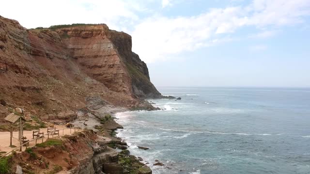 海浪撞击海滩岩石的鸟瞰图。葡萄牙海岸线上令人惊叹的悬崖海景。无人驾驶飞机。视频素材