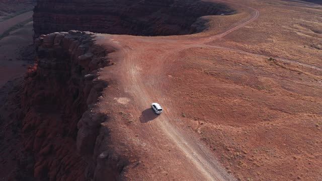 无人机视角:在Shafer trail Canyonlands上空飞过一辆越野汽车视频素材