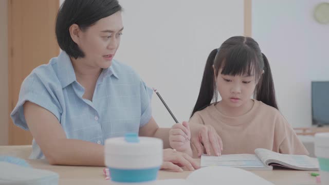 年幼的女儿在家与母亲学习在家教育和远程学习视频素材