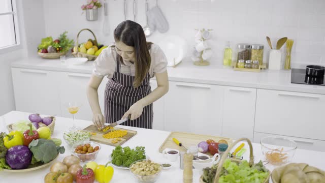 年轻女子用刀切胡萝卜视频素材