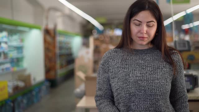 年轻女性购买蔬菜在商店的食品概念。挑选辣椒视频素材