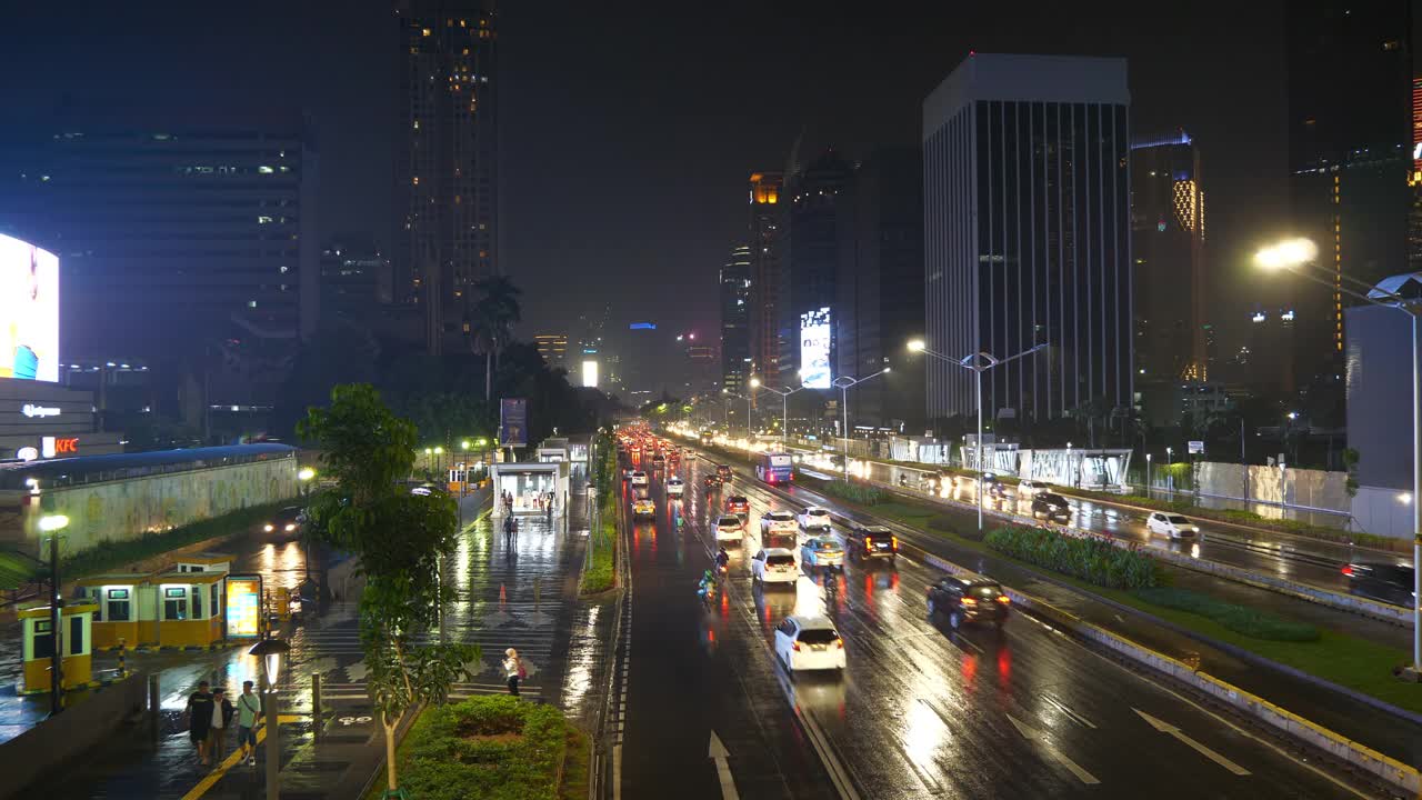 雨夜时间照明雅加达市中心交通街道道路顶部4k全景印尼视频素材