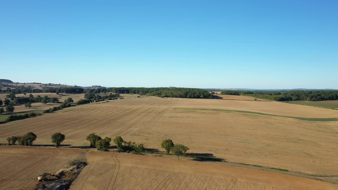 在法国勃艮第Nièvre的Cuncy les Varzy村，夏日和阳光明媚的一天，收获后的麦田和Mhers hammeau的绿色森林。视频素材