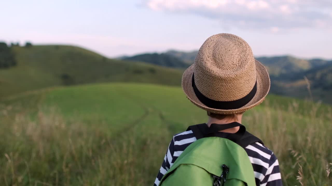 小男孩小孩年轻的徒步旅行者背包跑在山上旅行视频素材