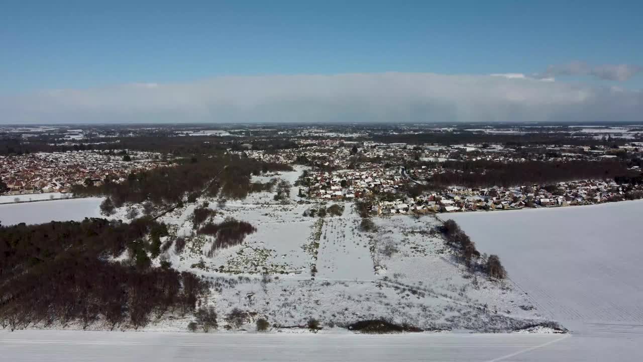 无人机拍摄的前英国皇家空军马特尔沙姆希思基地覆盖在雪中，英国萨福克视频素材