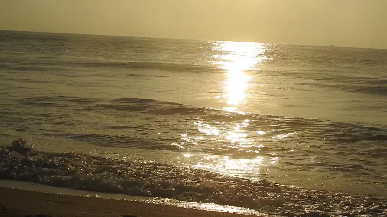 海面上的小波浪日落。金色的夕阳和黄色的阳光。《海边的日落》美丽的海上日落。日落与海浪视频素材