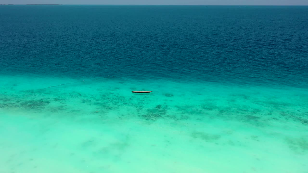 风景鸟瞰图的木材渔船漂浮在绿色的海洋在桑给巴尔岛，坦桑尼亚视频素材