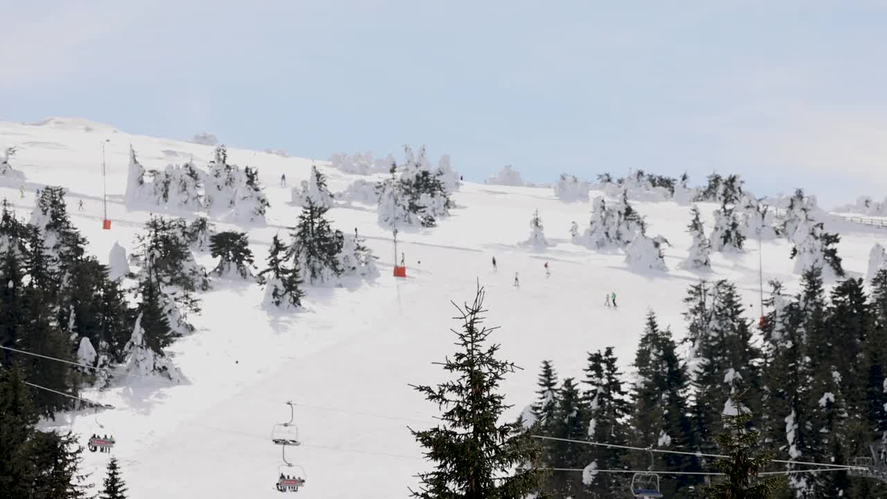 雪山滑雪坡道上的滑雪缆车和滑雪者视频素材