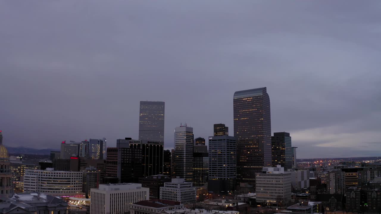 空中倾斜向上拍摄的建筑物对天空在城市，无人机飞越城市景观在黄昏-丹佛，科罗拉多州视频素材