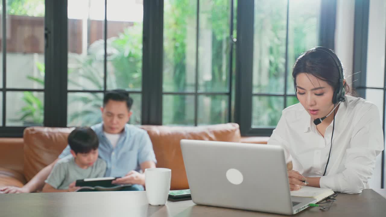 亚洲商务女性在视频会议中与同事团队讨论计划。一组商务人员使用计算机进行在线会议的视频电话会议。在家和家人一起工作。视频素材