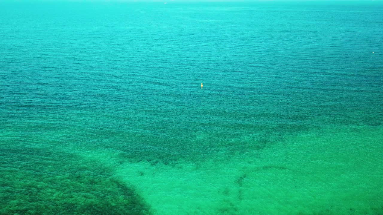 海上日落的鸟瞰图。美丽的蓝色大海和平静的大浪漂浮在太平洋上。海洋和天空背景景观。视频素材