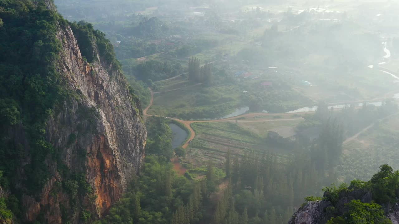 无人机拍摄的泰国松卡古哈山清晨的农田和山景，大雾弥漫视频素材