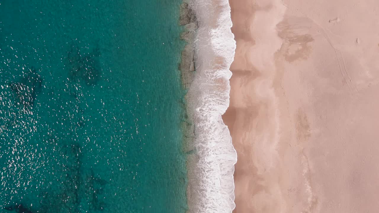 浪花在白色的沙滩上拍打。美丽的热带海滩上的海浪。海浪冲击着沙质海岸。碧波荡漾的海岸线视频素材