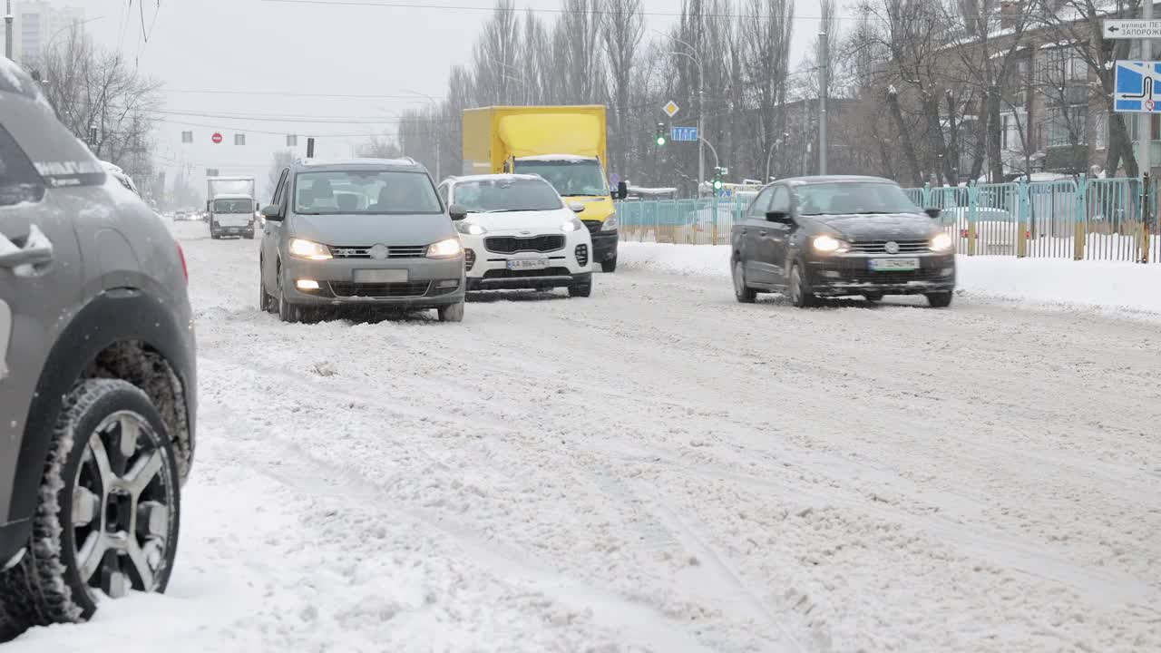 冬天下雪时城市道路上的汽车交通。视频素材