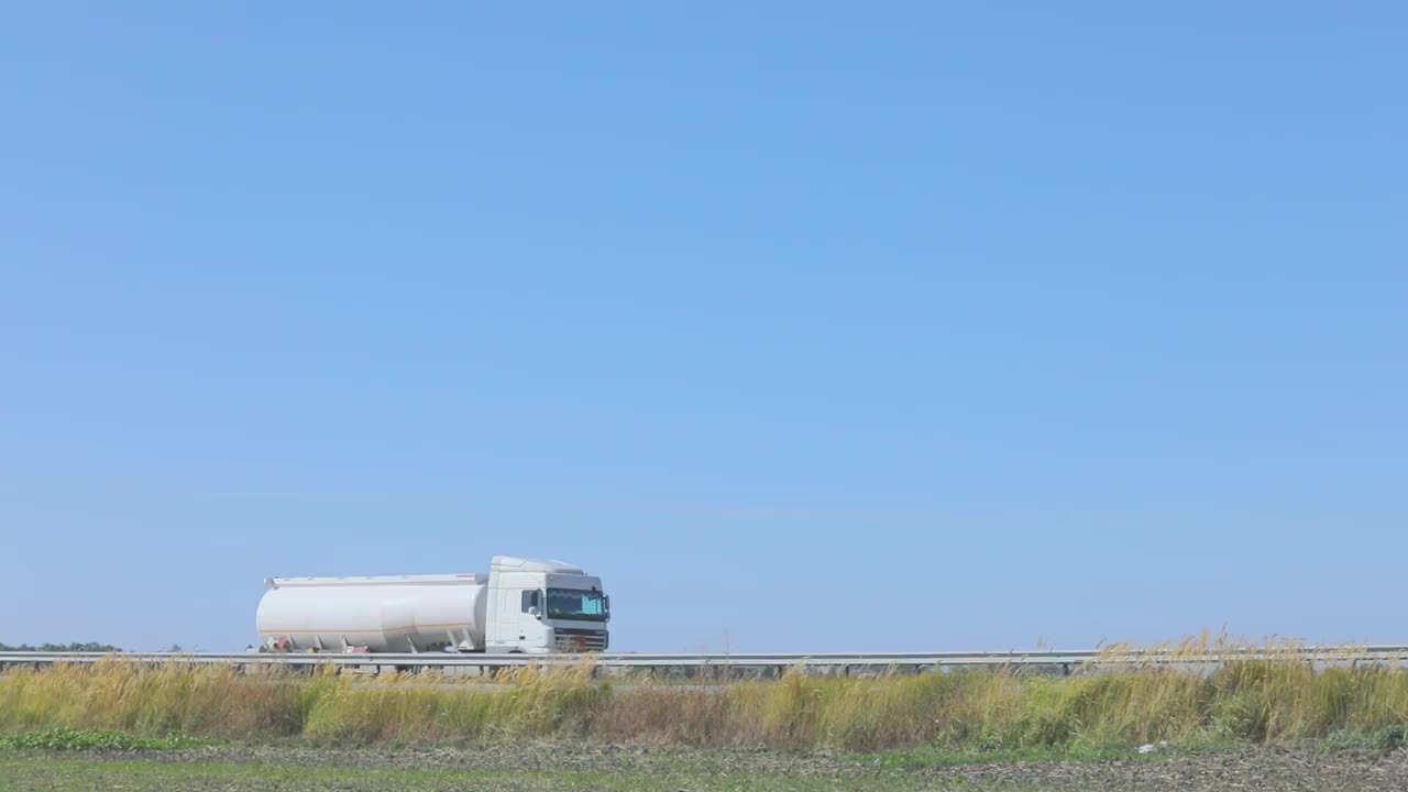 油罐车正沿着公路行驶。在城外高速公路上行驶的油罐车视频素材