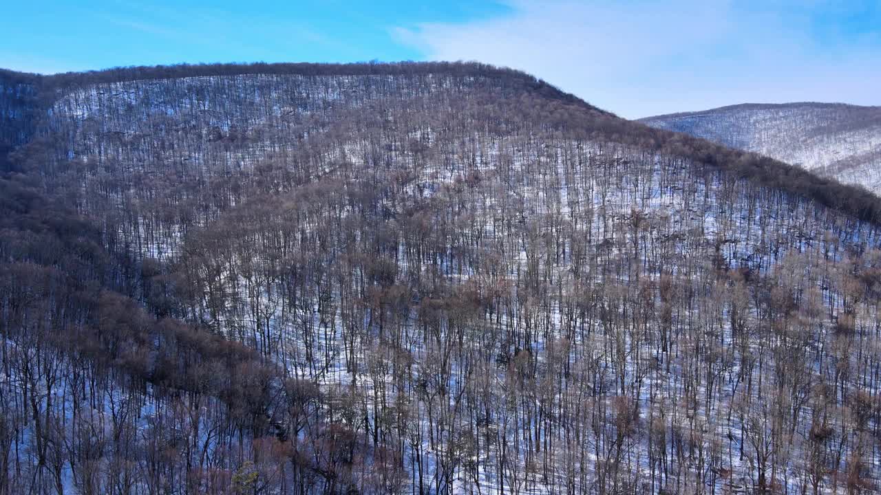 一架无人机拍摄的晴朗的雪山山谷，蓝天和一些云彩视频素材