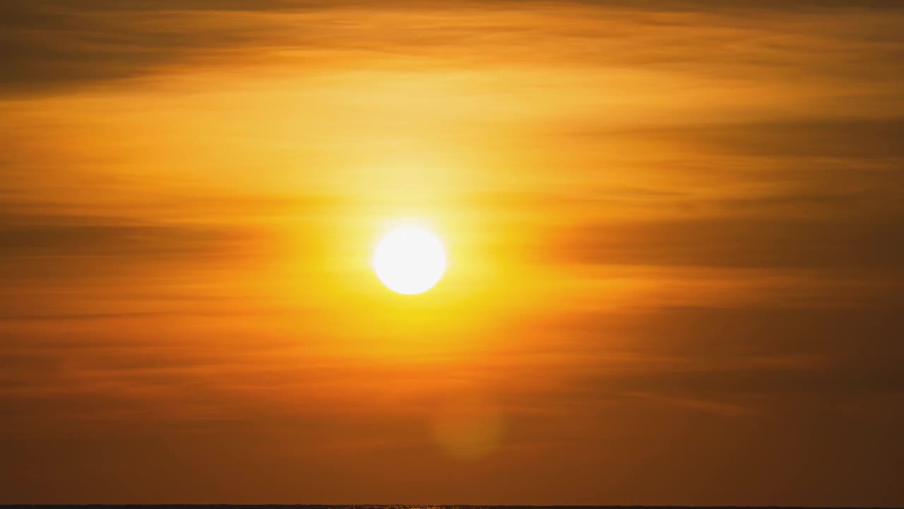 海外金色日落的时间流逝。在夏天的傍晚，圆形的橙色的太阳落入水中。景观自然日出背景。镜头b一卷太阳。黄色的日落的天空。美丽平静的海洋。视频素材