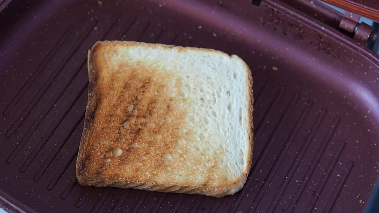 在烤三明治锅里做酥脆的吐司面包。视频素材