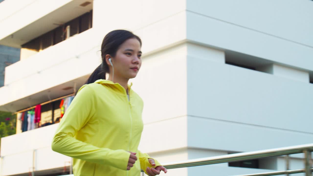 亚洲女性跑步街景美丽的日落，运动员运动跑步健身概念。视频素材