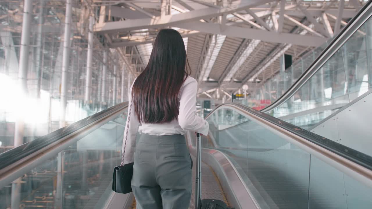 一名商务女性在国际机场戴着防护口罩，在新冠肺炎疫情下旅行，安全旅行，社交距离礼仪，新常态旅行理念视频购买