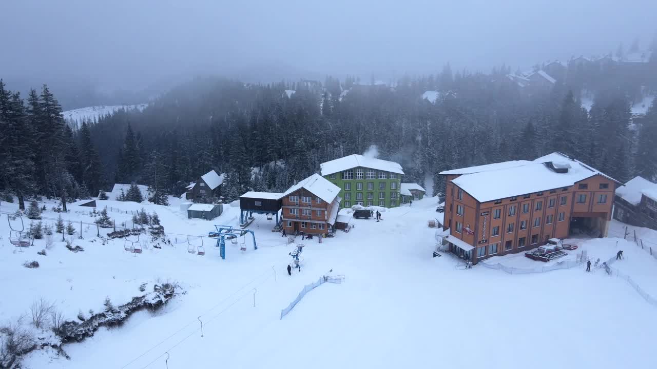 在暴风雪和降雪期间，无人机观看滑雪场。视频素材