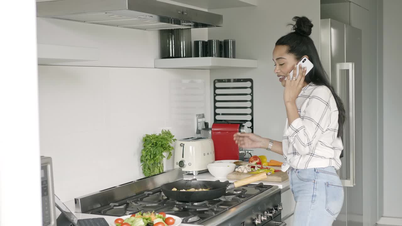 一边做饭一边打电话的女人视频素材