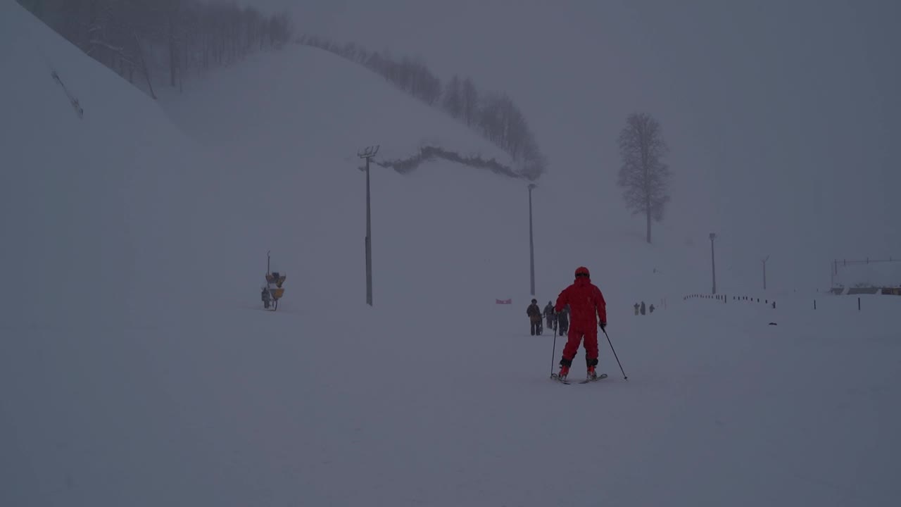 时光流逝-滑雪的人，大雪，雾和能见度差的斜坡在阿尔皮卡滑雪胜地。视频素材