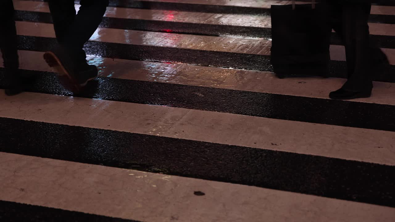 涉谷十字路口的一个雨天，高速拍摄行走的人的身体部位视频素材