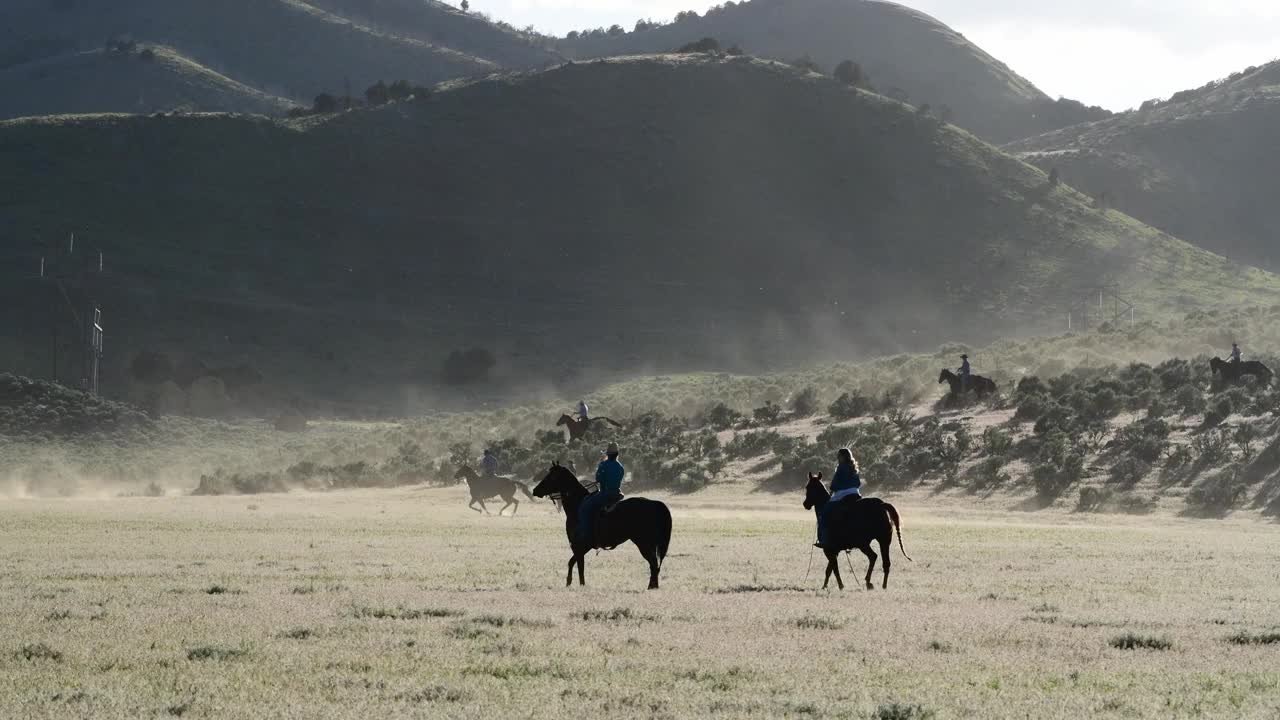 牛仔和马在犹他州山坡上奔跑的广角视频视频素材