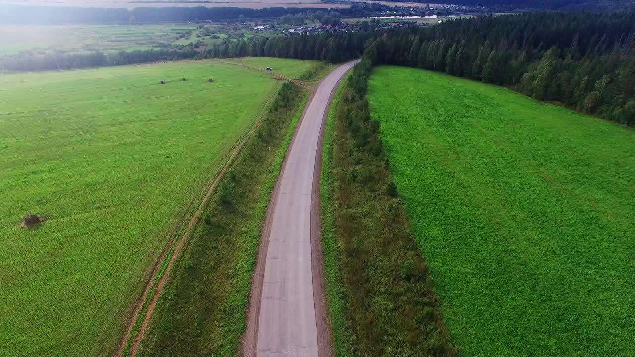 鸟瞰图无限空间的森林平原和汽车行驶在高速公路上。视频素材