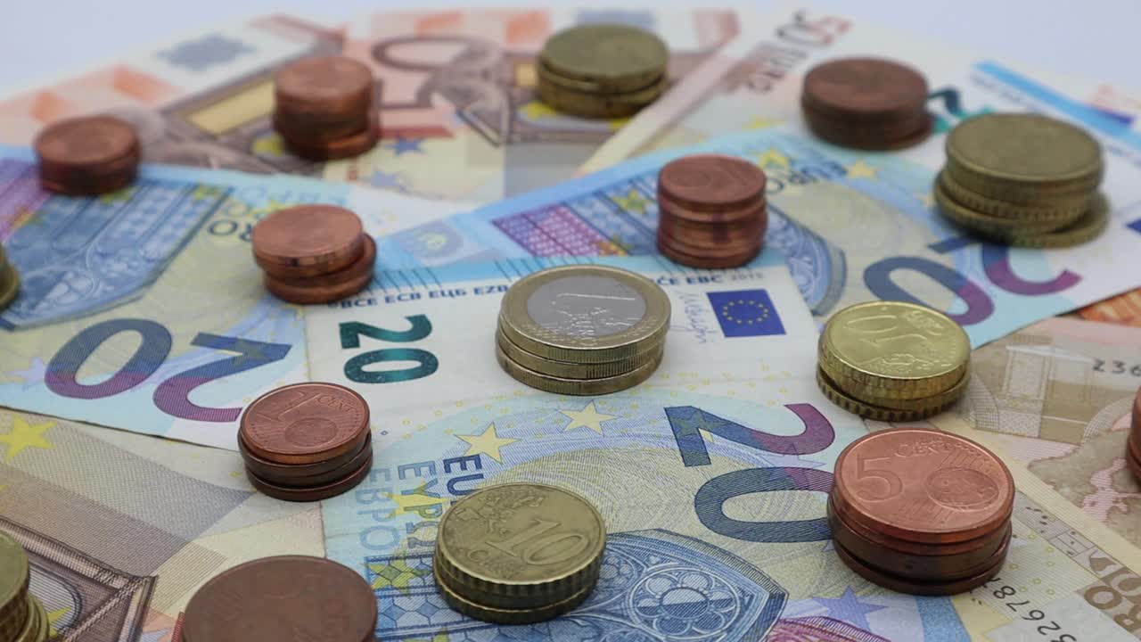 欧元纸币和欧元硬币旋转展示。视频素材
