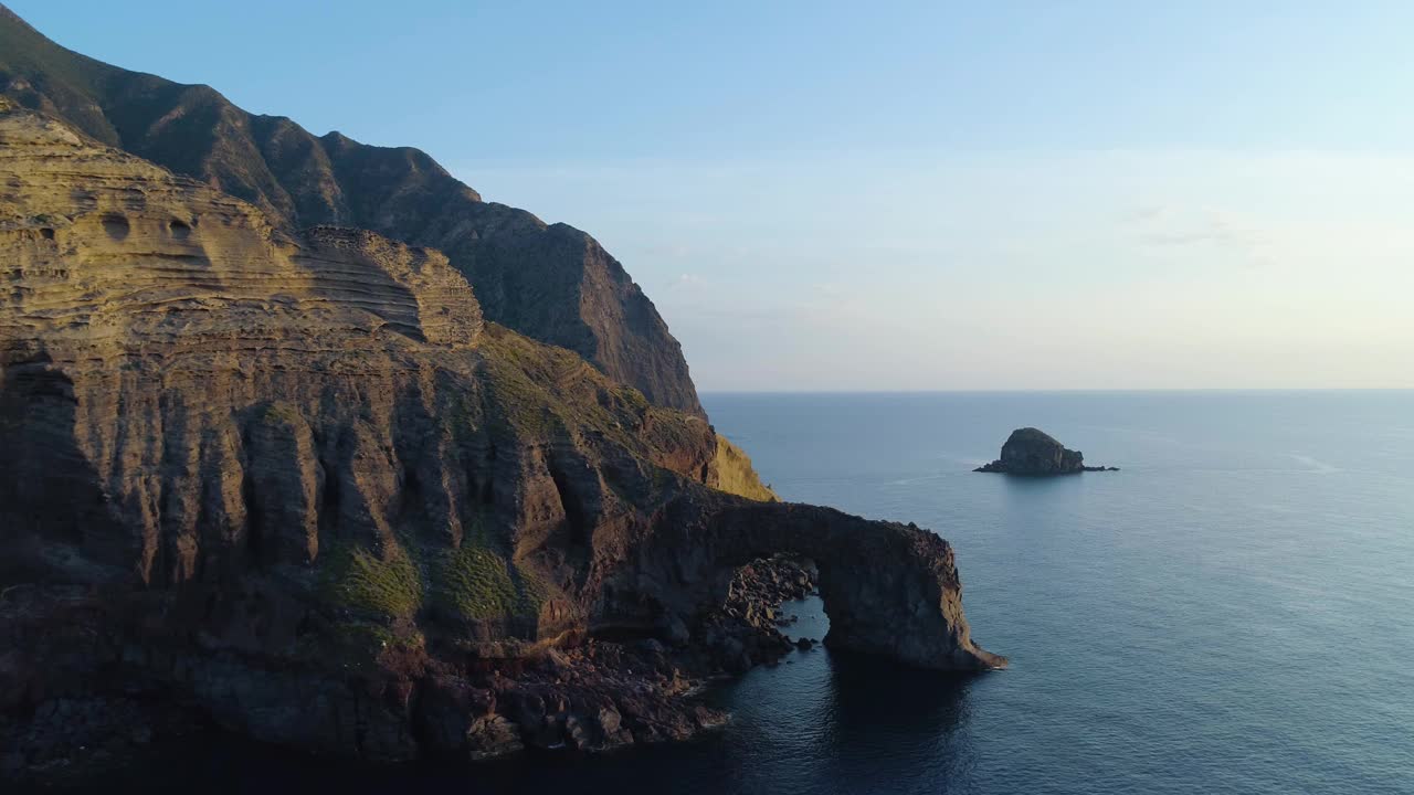 鸟瞰图萨利纳海岸，深悬崖，小村庄在一个夏天的日落。蓝色的海，蓝天和风，一个宁静的时刻。道路穿过山谷，巨大的山脉在背后视频素材