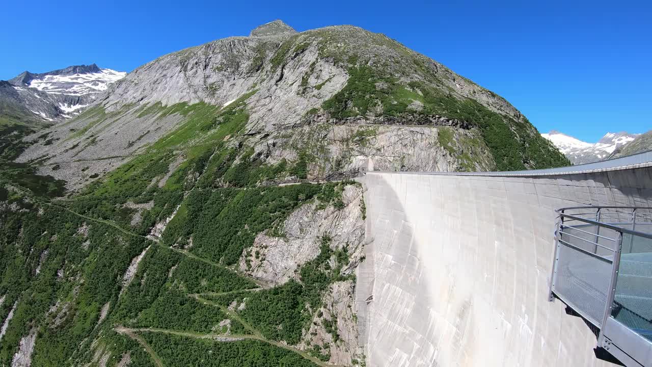 从奥地利卡林西亚Koelnbrein大坝上俯瞰山谷的全景。大坝被高山环绕着。陡峭的斜坡。山谷底部有一个长湖。自然能源视频素材