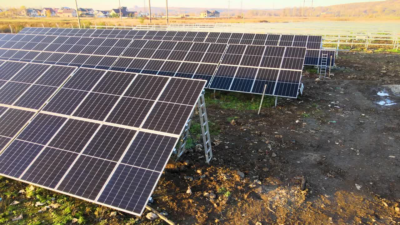 在绿地上建设太阳能发电厂。组装用于清洁生态能源生产的电板。视频素材