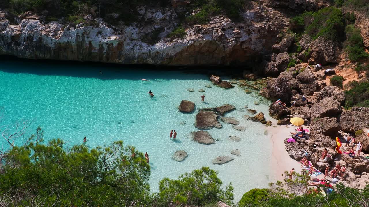 地中海的小海滩，清澈的海水，游客们在这里享受日光浴。马略卡岛的卡拉德尔莫罗岛。视频素材