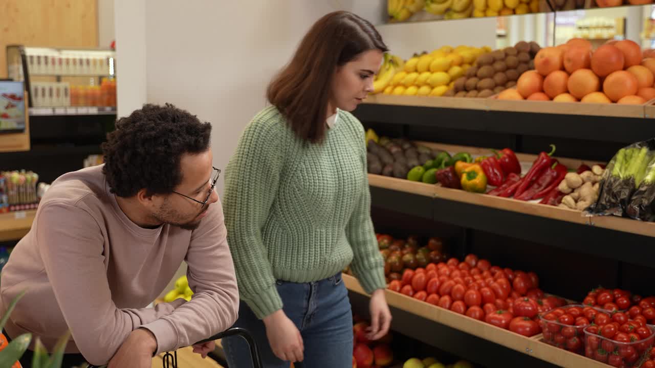 可悲的男人看着女人选择素食产品视频素材