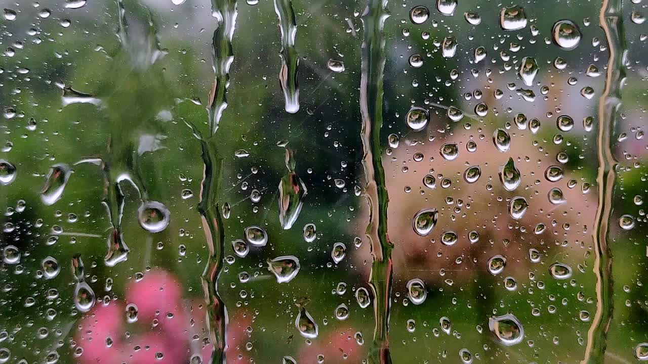 雨落在窗户表面。雨滴落在窗玻璃上视频素材