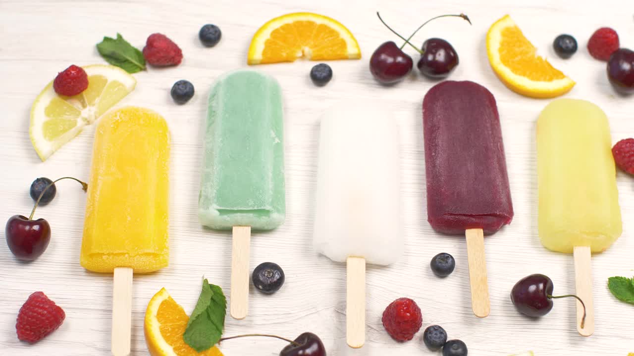 彩色冰柱与新鲜的水果在白色的背景视频下载