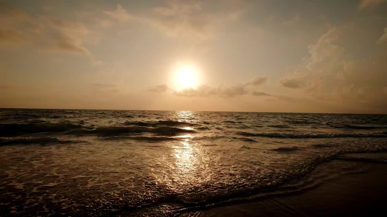 海上日出的超宽镜头。燃烧的天空和闪耀的金色波浪的慢动作。视频素材