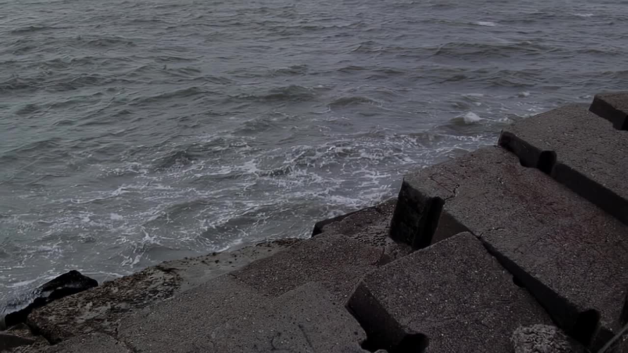 阿根廷，马德普拉塔，海浪拍打着海堤上的岩石。视频素材