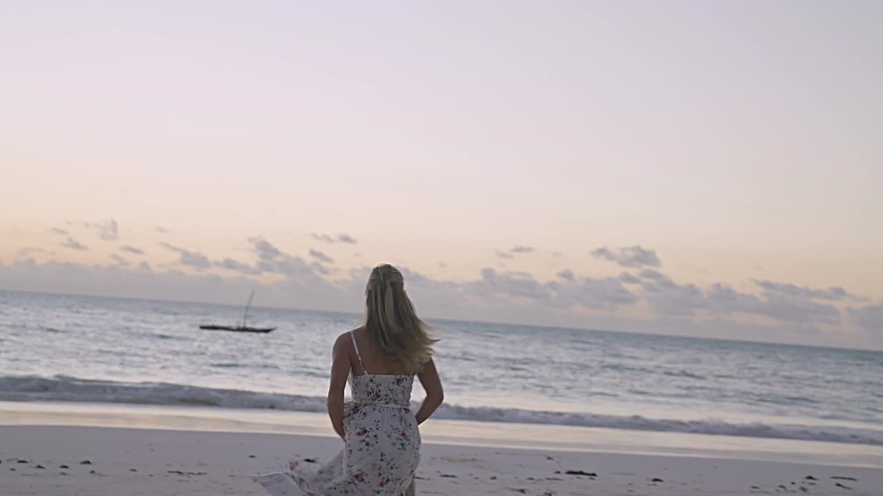 诱人的女人在夏天的衣服享受海滩日落视频素材