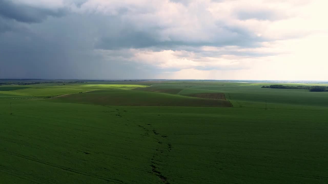 戏剧性的天空在下雨前与雨云在地平线上农村景观田野草地。视频素材