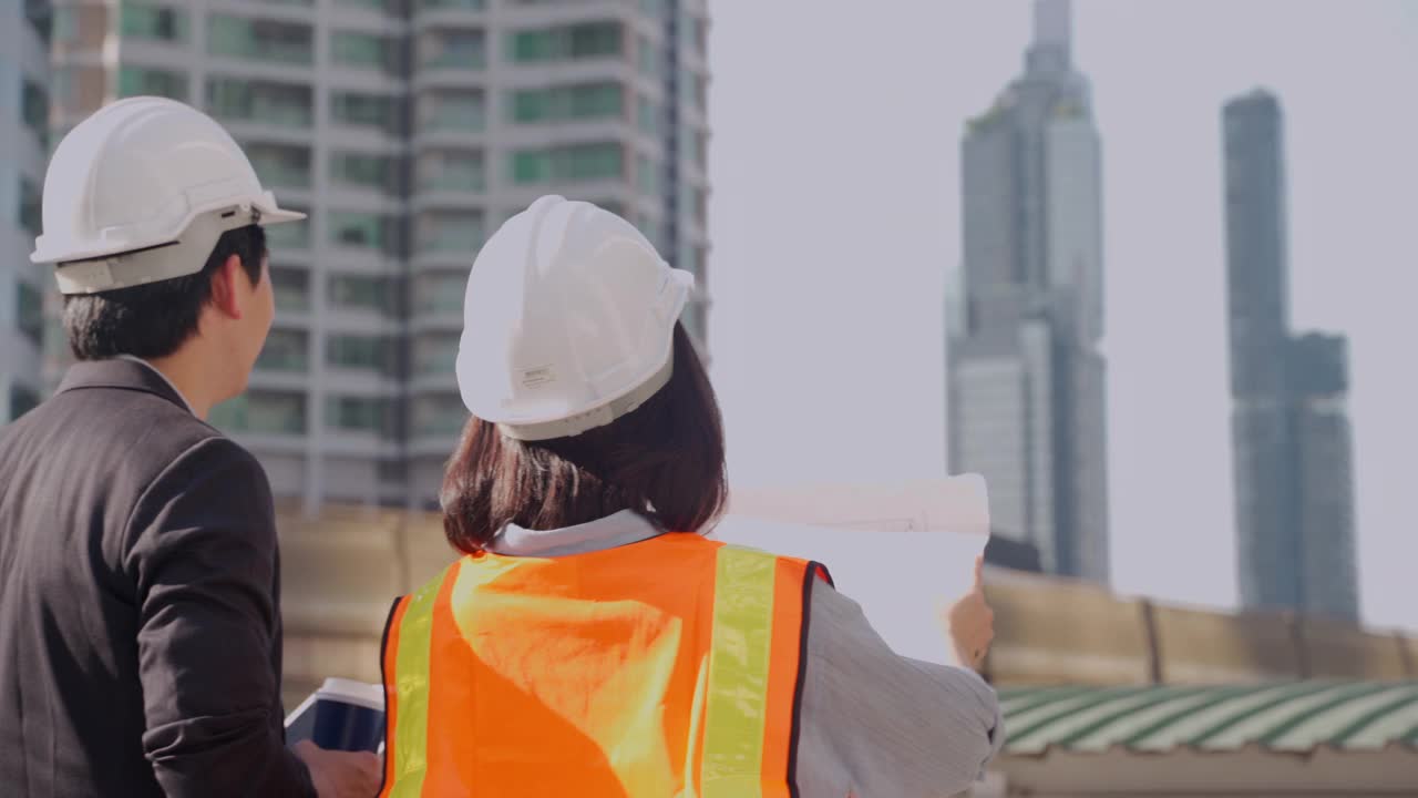 一男一女工程师的肖像，他们在讨论如何修复破损的设施。视频素材