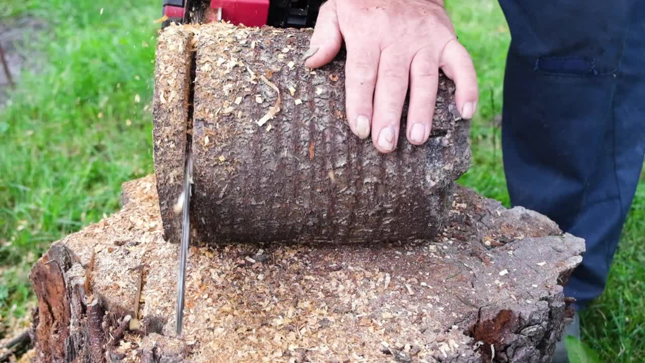 电池供电的无绳电锯切割木头。锯木头与链锯慢动作全高清视频特写。视频素材