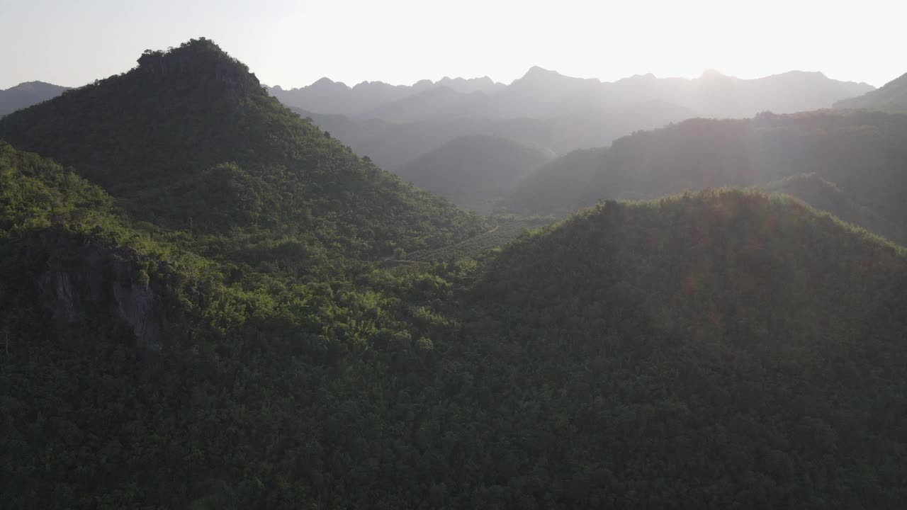 在夕阳的照耀下飞越青山，航拍视频素材